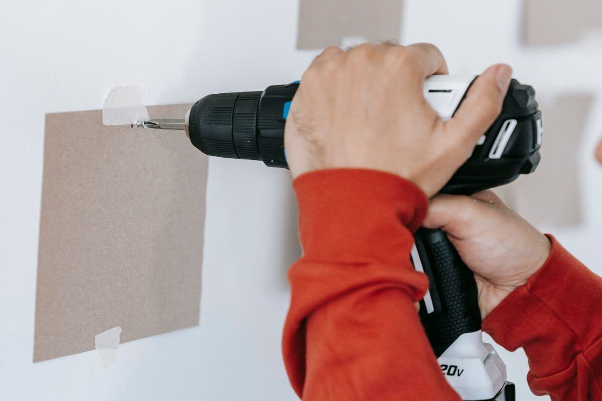 Drilling into a marked wall to fix a shelf