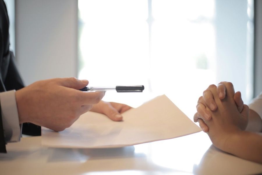 An insurance certificate handed across a table